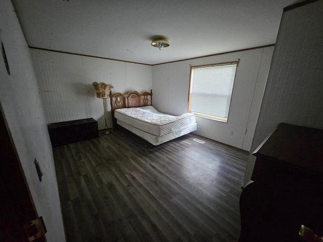 bedroom with dark wood-type flooring and ornamental molding