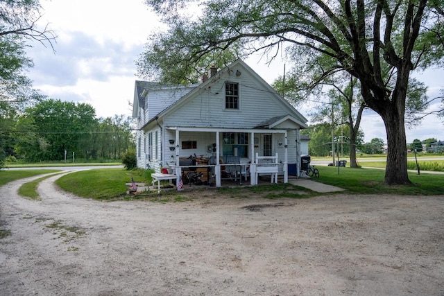 rear view of house featuring a lawn