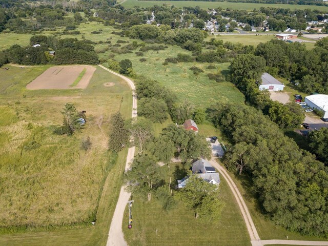 birds eye view of property with a rural view