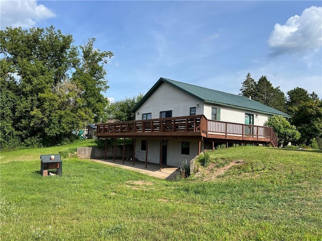 rear view of house with a yard, a deck, and a patio