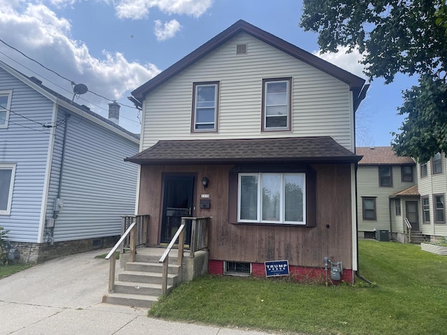 view of property with central AC and a front yard