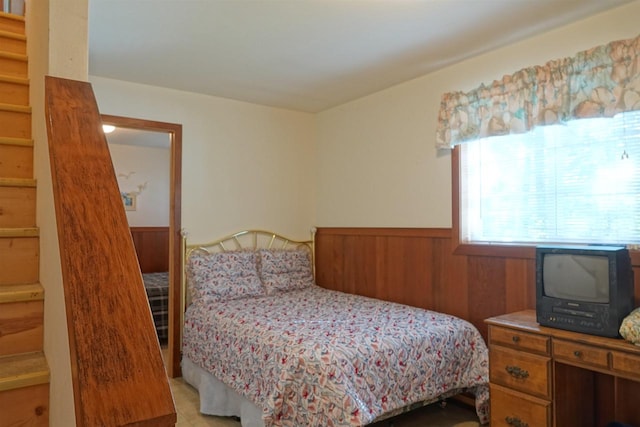 bedroom with wood walls