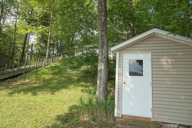 view of outbuilding with a yard