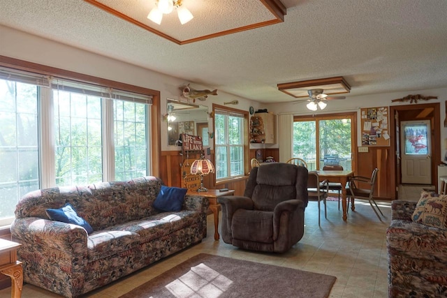 living room with ceiling fan and a textured ceiling