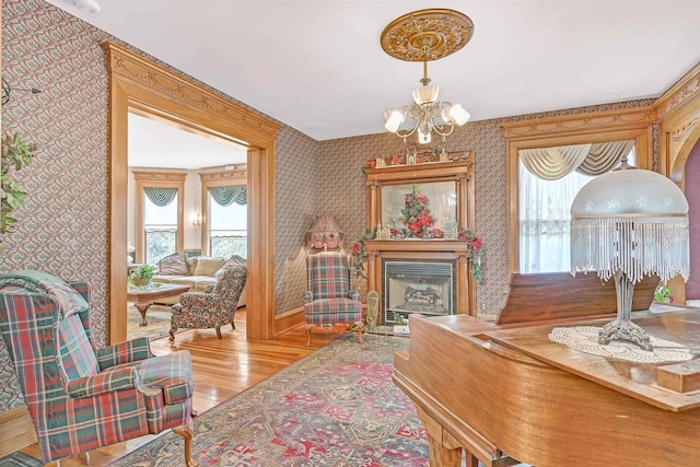 dining area with light wood-type flooring and an inviting chandelier