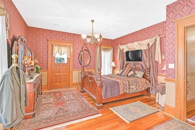 bedroom featuring light hardwood / wood-style flooring and a notable chandelier