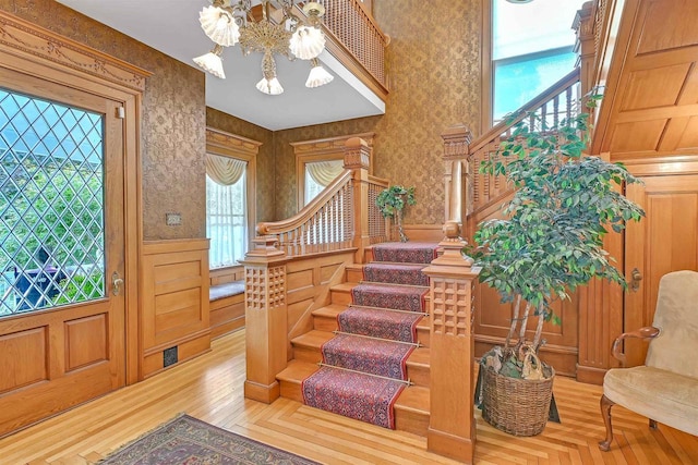 foyer entrance featuring hardwood / wood-style floors and an inviting chandelier