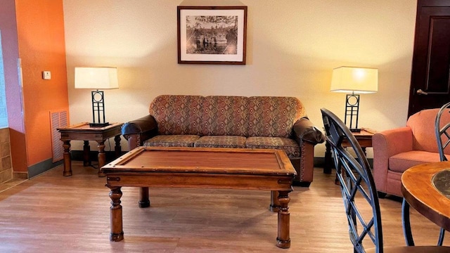 living room featuring light hardwood / wood-style floors and billiards