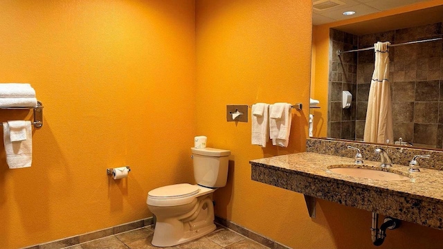 bathroom featuring sink, tile patterned flooring, toilet, and a shower with shower curtain