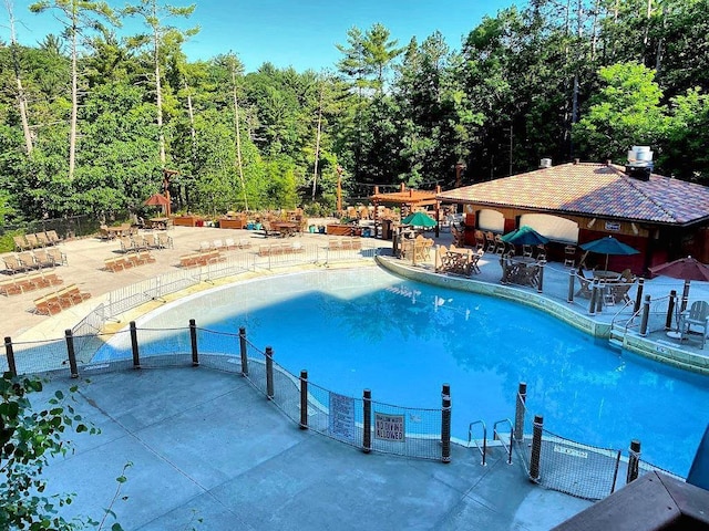 view of swimming pool with a patio area