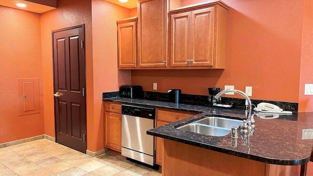 kitchen with light tile patterned floors, dark stone countertops, dishwasher, electric panel, and sink