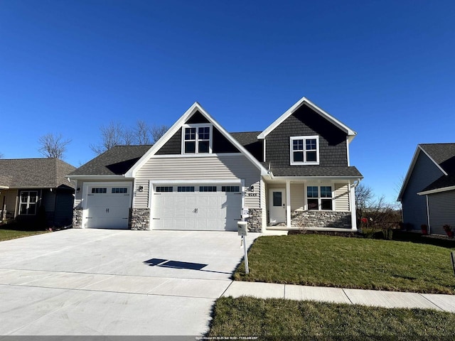 craftsman inspired home with a front lawn and a garage