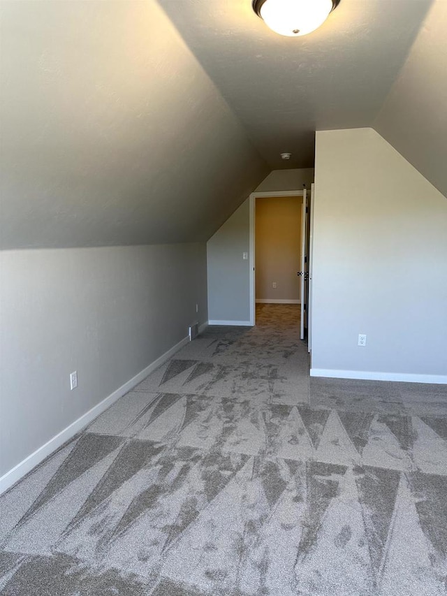 bonus room featuring carpet and vaulted ceiling