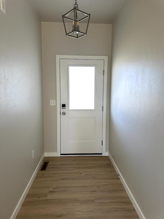 entryway featuring a notable chandelier and hardwood / wood-style floors