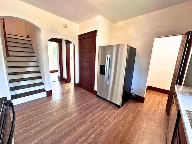 kitchen featuring stainless steel fridge with ice dispenser and hardwood / wood-style floors