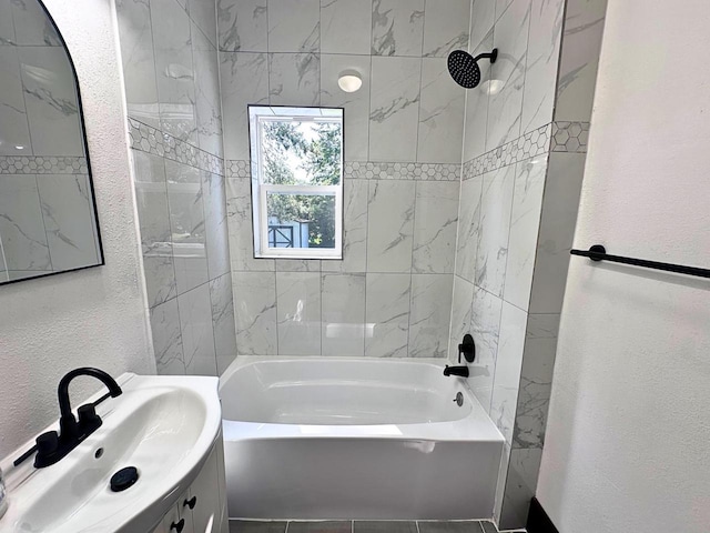 bathroom featuring tiled shower / bath combo, tile patterned floors, and vanity