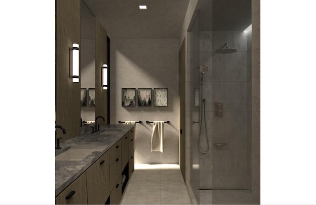 bathroom with vanity, a tile shower, and tile patterned flooring