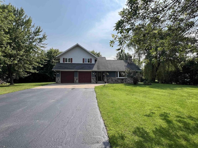 view of property featuring a front yard and a garage