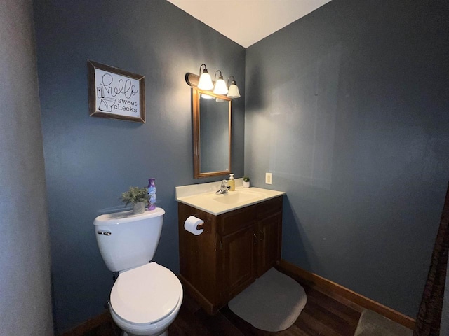 bathroom featuring hardwood / wood-style flooring, vanity, and toilet