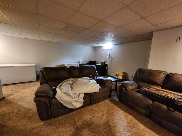 carpeted living room with a drop ceiling