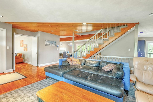 living room with wooden ceiling, wood-type flooring, and a notable chandelier