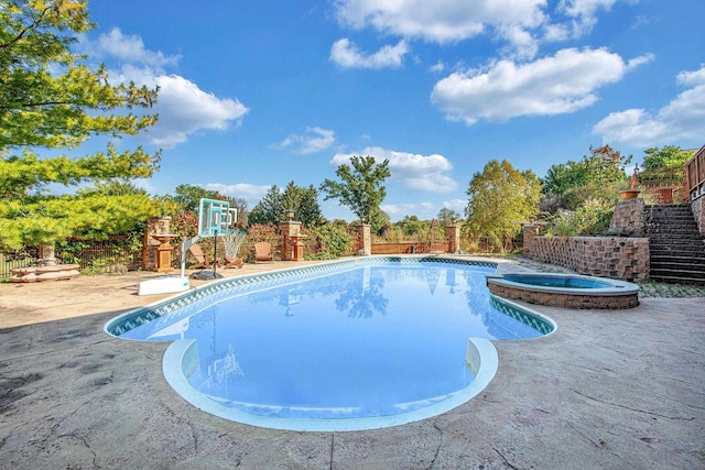 view of swimming pool with an in ground hot tub and a patio area