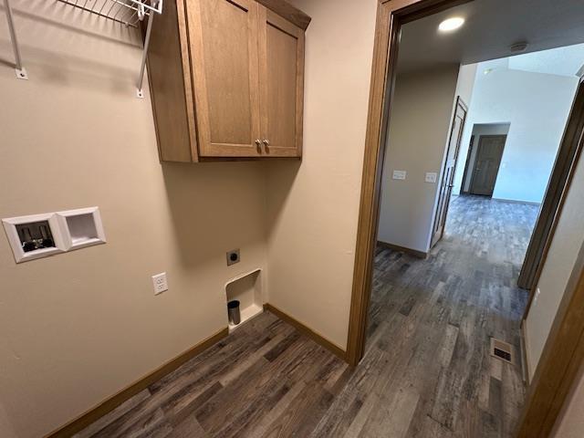 laundry room featuring cabinets, dark wood-type flooring, electric dryer hookup, and washer hookup