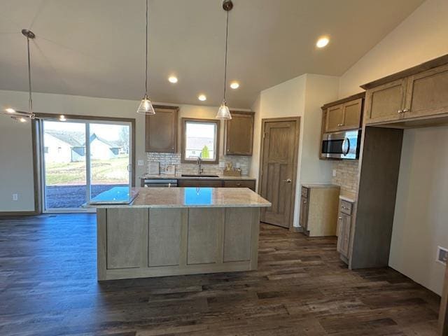 kitchen featuring a kitchen island, decorative light fixtures, tasteful backsplash, dark hardwood / wood-style floors, and vaulted ceiling