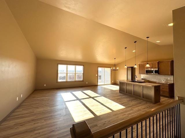 interior space featuring lofted ceiling, sink, a chandelier, and hardwood / wood-style floors