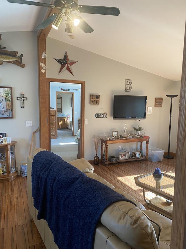 living room featuring lofted ceiling, hardwood / wood-style floors, and ceiling fan