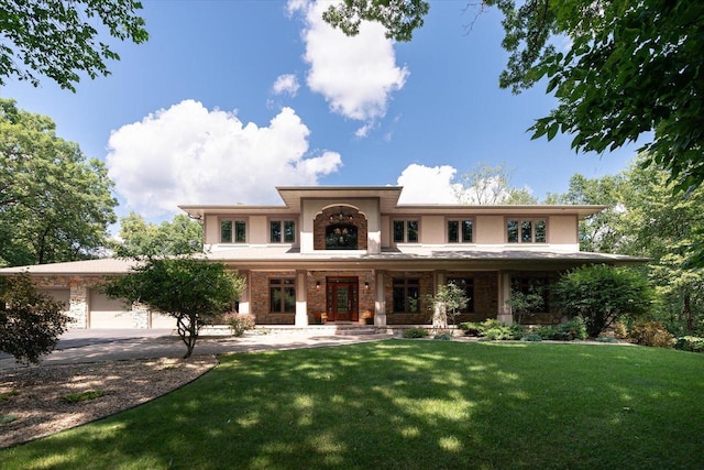 view of front of property with a front lawn and a garage