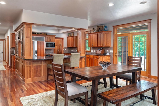 3031 Wild Rose Ln, Onalaska, WI 54650 - dining space featuring light hardwood / wood-style floors and decorative columns