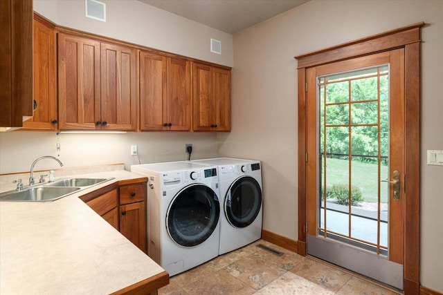 3031 Wild Rose Ln, Onalaska, WI 54650 - clothes washing area featuring cabinets, sink, and washing machine and clothes dryer