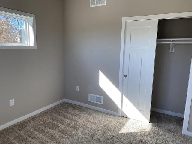 unfurnished bedroom featuring a closet and carpet floors