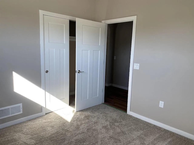 unfurnished bedroom featuring a closet and carpet