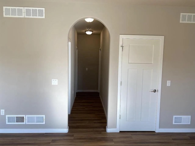 corridor with dark hardwood / wood-style floors