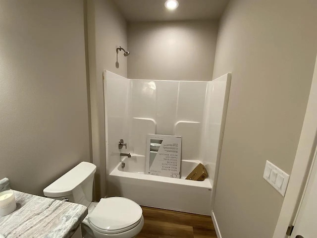 bathroom with toilet,  shower combination, and hardwood / wood-style flooring