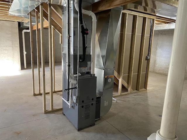 utility room featuring heating unit