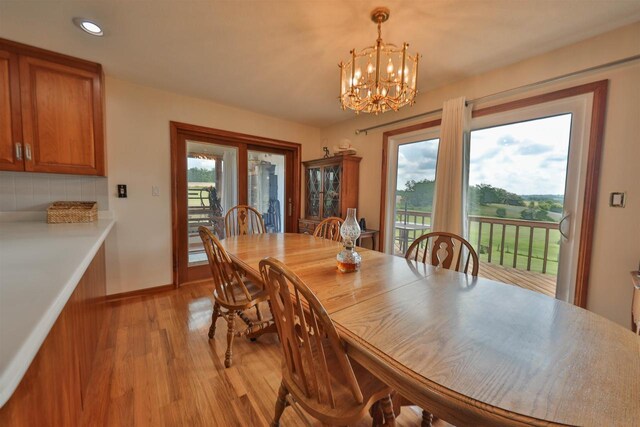 dining room featuring light hardwood / wood-style flooring and a notable chandelier