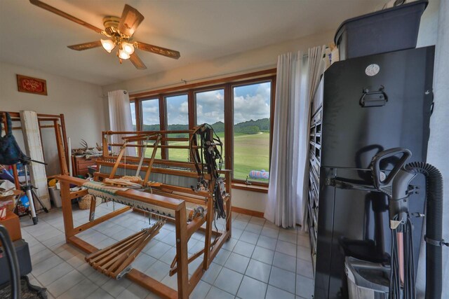 dining area with ceiling fan and light tile patterned floors