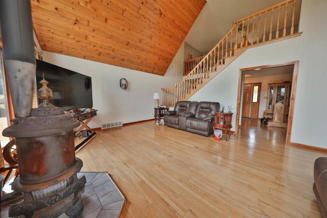 living room featuring wood ceiling, high vaulted ceiling, and light hardwood / wood-style flooring