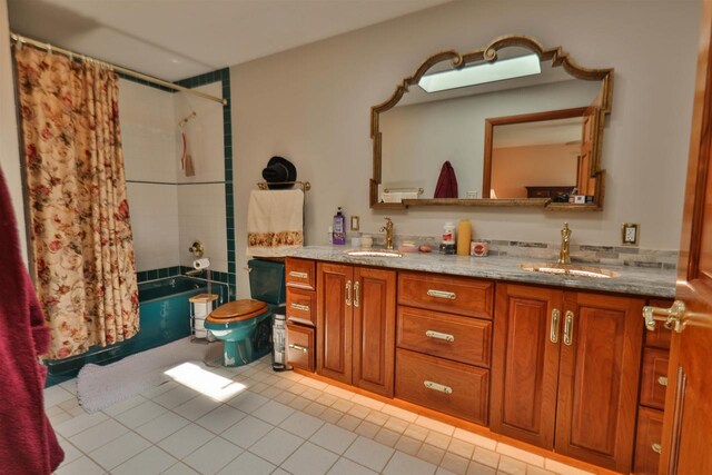 bathroom with tile patterned floors, vanity, and shower / tub combo with curtain