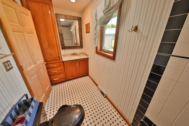 bathroom featuring vanity, tile patterned floors, and decorative backsplash