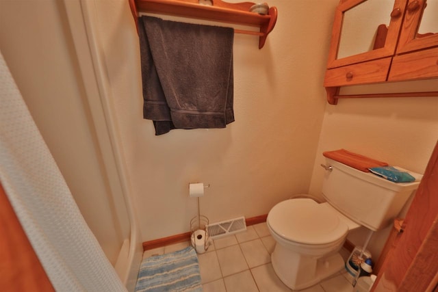 bathroom featuring tile patterned flooring and toilet