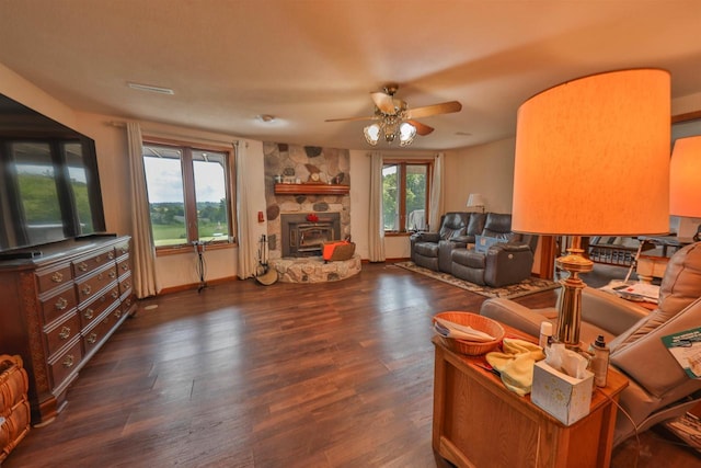 living room with dark wood-type flooring, plenty of natural light, and ceiling fan