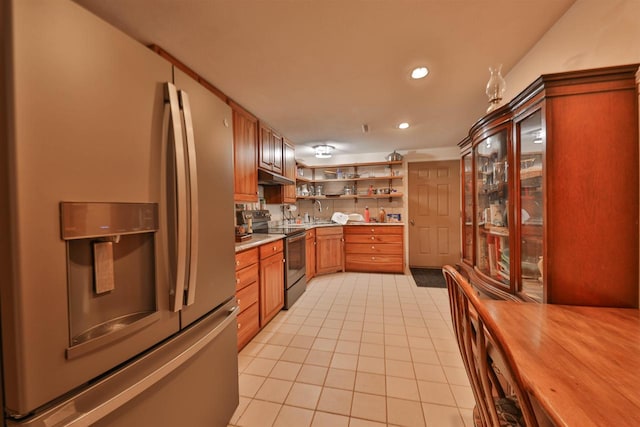 kitchen featuring light tile patterned flooring, sink, electric range oven, and stainless steel fridge with ice dispenser