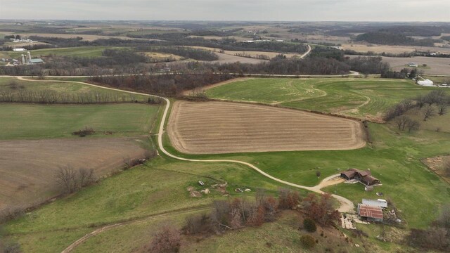 birds eye view of property with a rural view