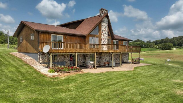 back of property featuring a patio area, a deck, and a yard