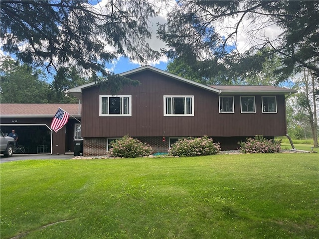 view of side of property featuring a yard and a garage