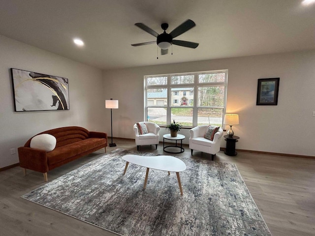 living room featuring ceiling fan and hardwood / wood-style floors